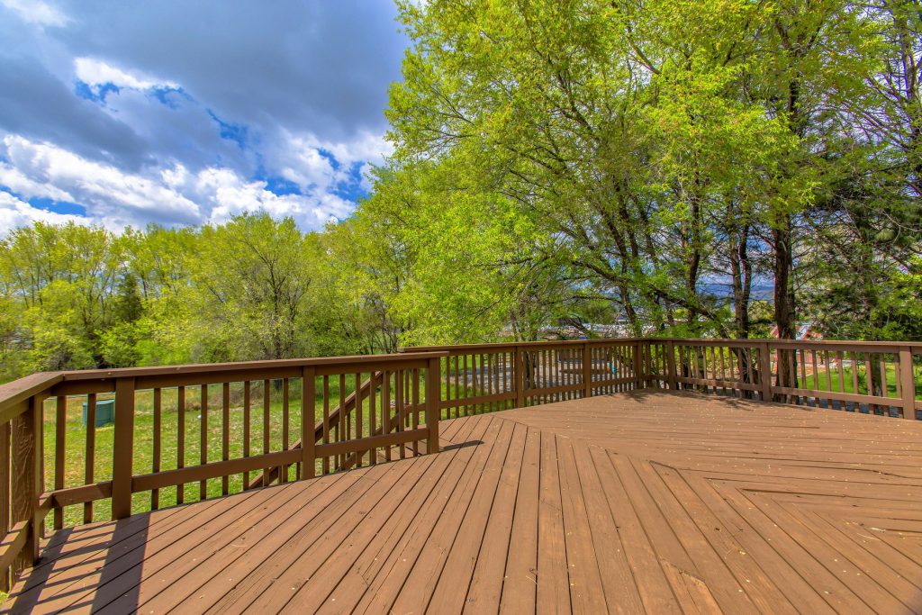 A weathered wood deck before staining in Western New York
